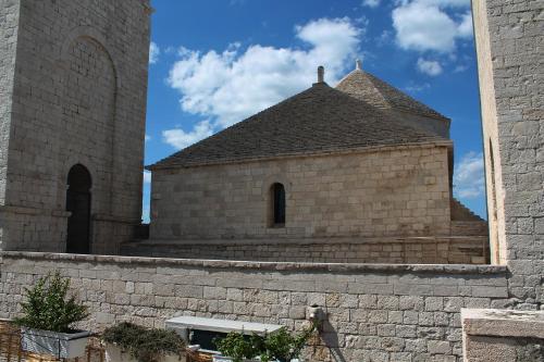 a building with a tower and a brick wall at Il Mulino di Amleto - Bed and Breakfast letterario in Molfetta