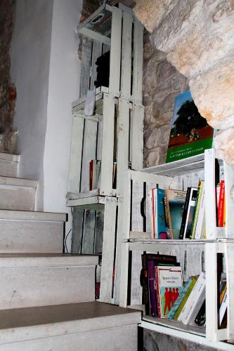 a book shelf with books on it next to some stairs at Il Mulino di Amleto - Bed and Breakfast letterario in Molfetta