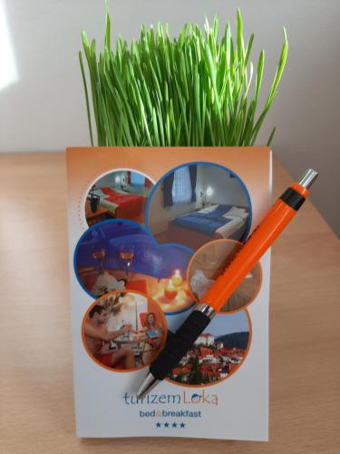 a pen sitting on top of a box on a table at Boutique Hotel Loka in Škofja Loka
