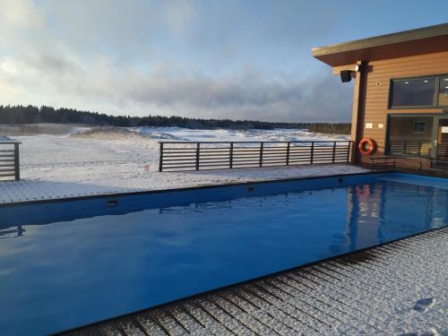 a swimming pool in front of a house at Gorki Golf Resort in Gorki