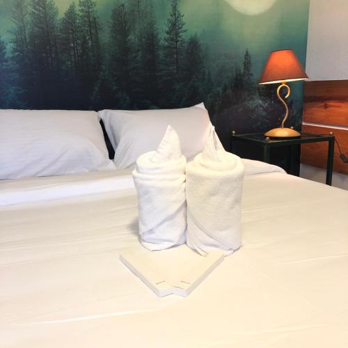 two towels are sitting on top of a bed at Casa Generosa in Baguio