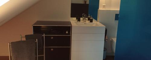 a bathroom with a sink and a counter with a staircase at B&B Tomsi in Pratteln