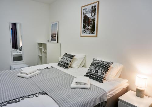 a bedroom with a bed with two pillows on it at Inn Tourist Hostel in Helsinki