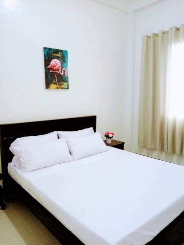 a bedroom with a large white bed with a window at Casa Loreta Hotel in Numancia