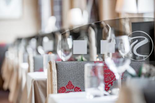 a row of tables with wine glasses on them at SKI - GOLF - WELLNESS Hotel Riml in Hochgurgl