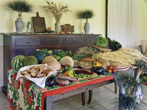 a table filled with lots of fruits and vegetables at Su Massaiu in Turri