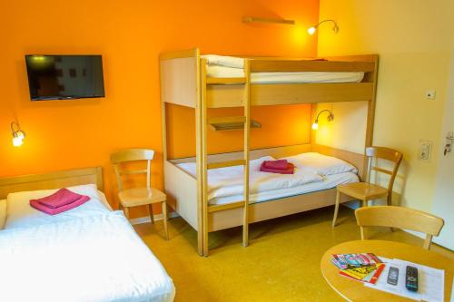 a room with two bunk beds and a table at Schanzenstern Altona GmbH in Hamburg