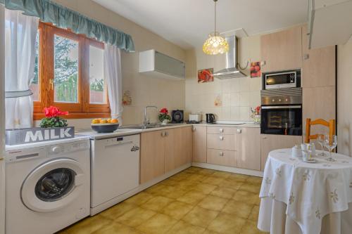a kitchen with a washer and dryer in it at CAN COSTA Amazing view of sunset on the sea in Cala Vadella