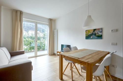 a living room with a wooden table and a couch at Appartamenti 1 in Dervio