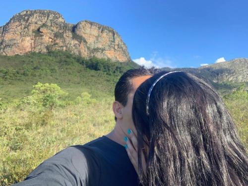 a man with long hair looking at a mountain at Pouso do Elefante in Serra do Cipo