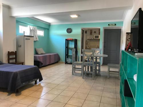 a room with a bed and a table and chairs at Departamento Belgrano 7 in Salta