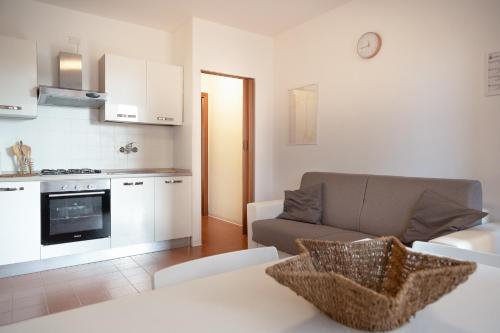 ein Wohnzimmer mit einem Sofa und einer Küche in der Unterkunft Appartamenti Angelica 21 in Pisa