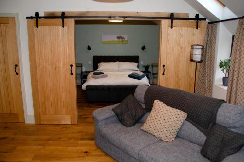 a living room with a couch and a bed at The Smithy in Ilkley