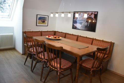 a dining room with a wooden table and chairs at Landhaus am Pyhrn in Pyhrn