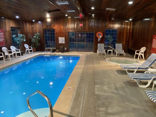 a large swimming pool with chairs at Budget Inn Express in Gillette