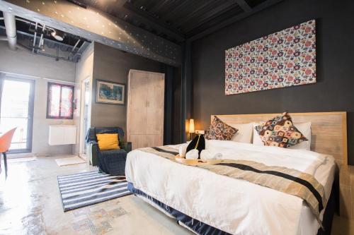 a bedroom with a large bed and a couch at Zozola in Hengchun South Gate