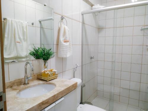 a bathroom with a sink and a toilet and a shower at Accord Hotel in Castanhal