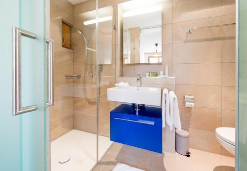 a bathroom with a sink and a shower at Panoramapark Soleil Chalet B in Wengen