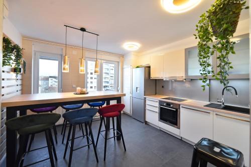a kitchen with a table and stools at First Choice Ilica - Spacious 3-Bedroom Apartment with Parking in Zagreb