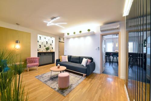 a living room with a couch and a table at First Choice Ilica - Spacious 3-Bedroom Apartment with Parking in Zagreb