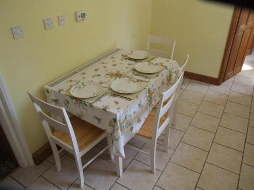 une table à manger avec des chaises et un tissu de table floral dans l'établissement firtrees, à Selby