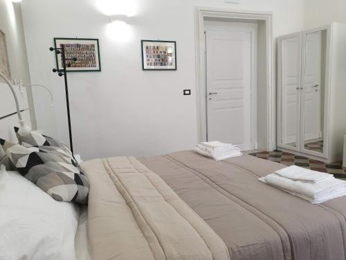 a bedroom with a large bed in a room at Duomo Rooms b&b in Lentini