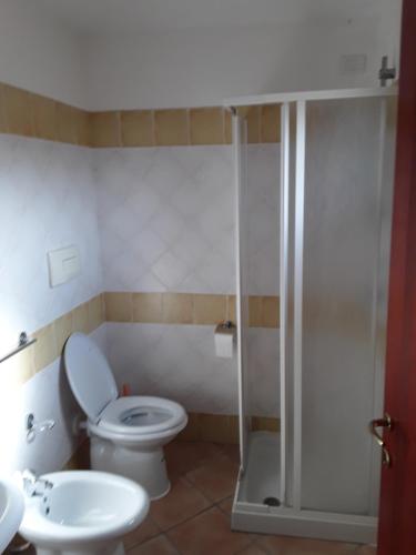 a bathroom with a toilet and a shower at Da Claudio gli oleandri residence in Olbia