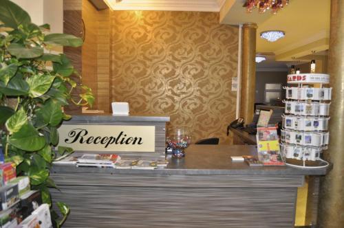 a cashier counter in a store with a sign that reads reception at Hotel Prestige in Brussels