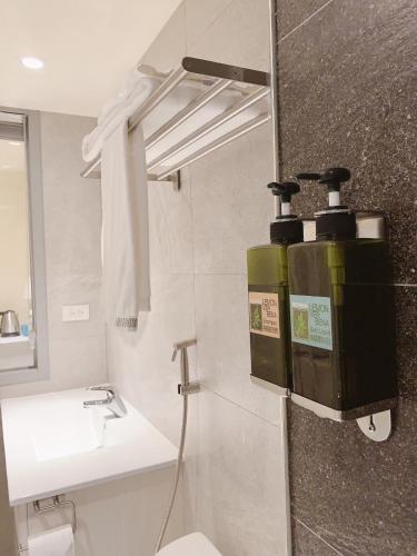 a bathroom with a toilet and a sink at 日出逢甲 in Taichung