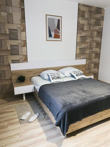 a bedroom with a large bed with a wooden headboard at Розкішна квартира. Подобово. Центр! in Ternopilʼ