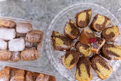 two plastic containers filled with different types of pastries at Park Hotel in Rimini
