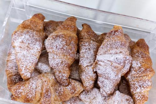 a plastic container of pastries covered in powdered sugar at Park Hotel in Rimini