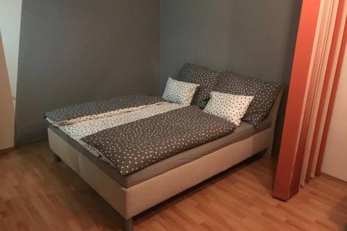 a bed with pillows on it in a room at Apartman QUATTRO in Sokolov