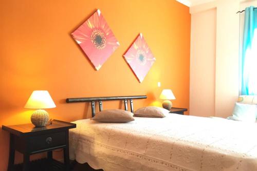 a bedroom with a bed with two tables and two lamps at Edificio Sao Joao das areias Strip l OURA in Albufeira