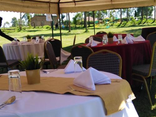 a group of tables with white napkins on them at Lantana Comfy in Kakamega