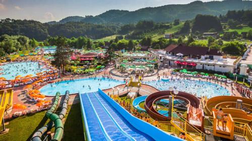 an amusement park with a large pool and slides at Cottage house 92 Auqaluna in Podčetrtek