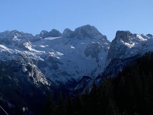 a large mountain range with snow on it at Dachstein Mountainview Gosau in Gosau