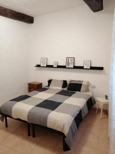 a bedroom with a large bed with two pictures on the wall at Casa Anna in Siena