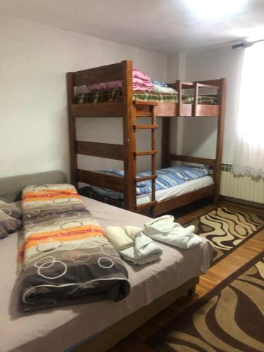 a bedroom with two bunk beds and two at Villa Anastasoski in Mavrovo