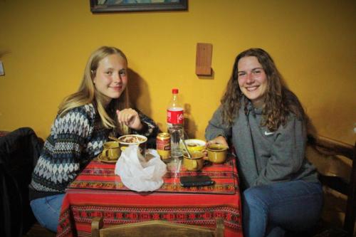 two girls sitting at a table with drinks at Vip House in Cusco