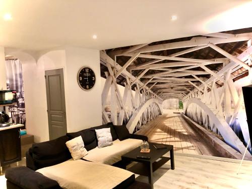 a living room with a bridge mural on the wall at Lulu Philipp coté cour in Saint-Étienne