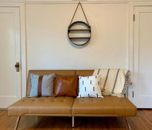 a couch with pillows on it in a living room at Riverpath Inn in Eugene