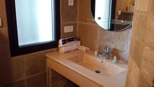 a bathroom with a sink and a mirror at Castelia in Lumio