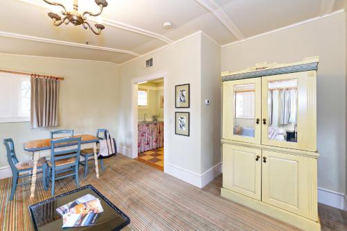 a living room with a table and a dining room at Tallman Hotel in Upper Lake