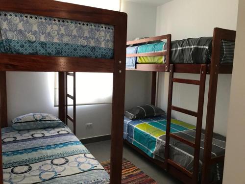 two bunk beds in a room with a bed at PARADISE EN VICHAYITO II in Vichayito