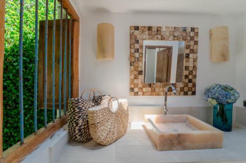a bathroom with a sink and a mirror at Villa Saffira in Seminyak