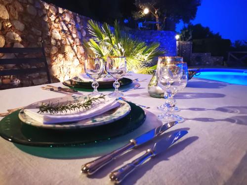 a table with plates and wine glasses on top of it at Due Esperienza Panoramica in Lamezia Terme