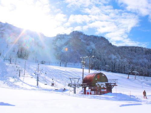 a snow covered ski slope with a dome in the snow at Ichirino Kogen Hotel Roan in Hakusan
