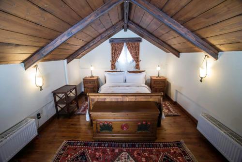 a bedroom with a bed in a attic with two lamps at Galaxidi Mansion in Galaxidhion