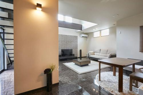 a living room with a couch and a table at Chie's house in Mitaka